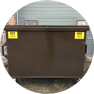 A brown dumpster sitting in front of a building.